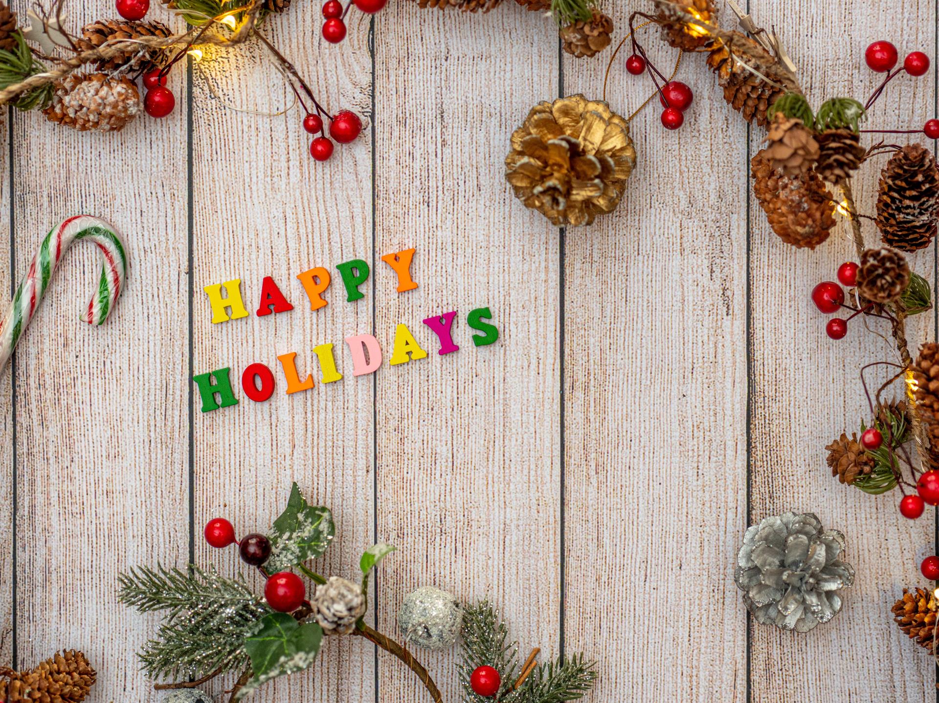 Happy Holidays Lettering over wood background