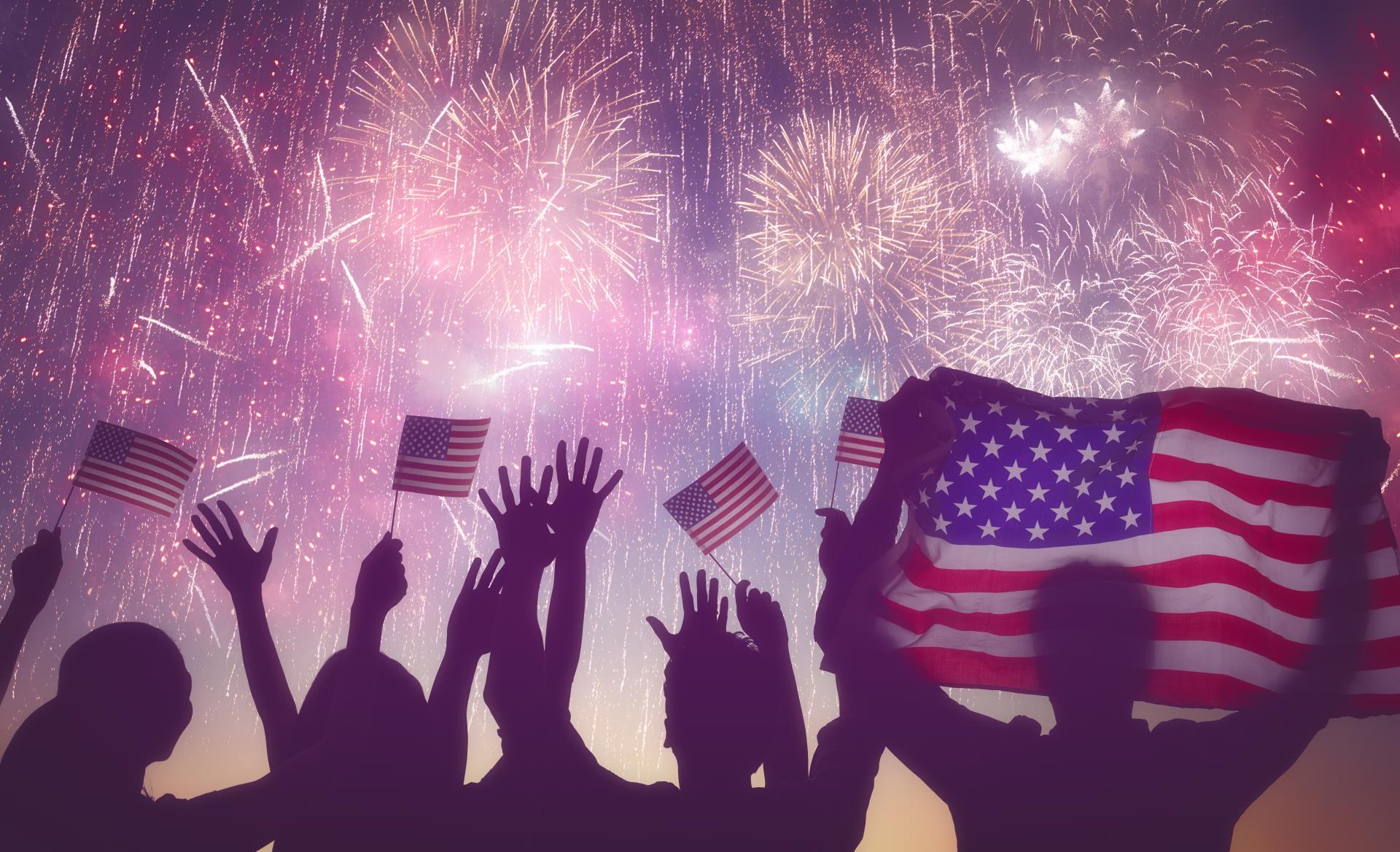 people celebrating with flags and fireworks