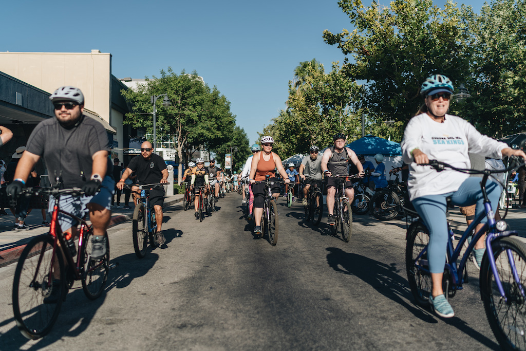 bicyclists ride down Lancaster BLVD at the start of tour de luke