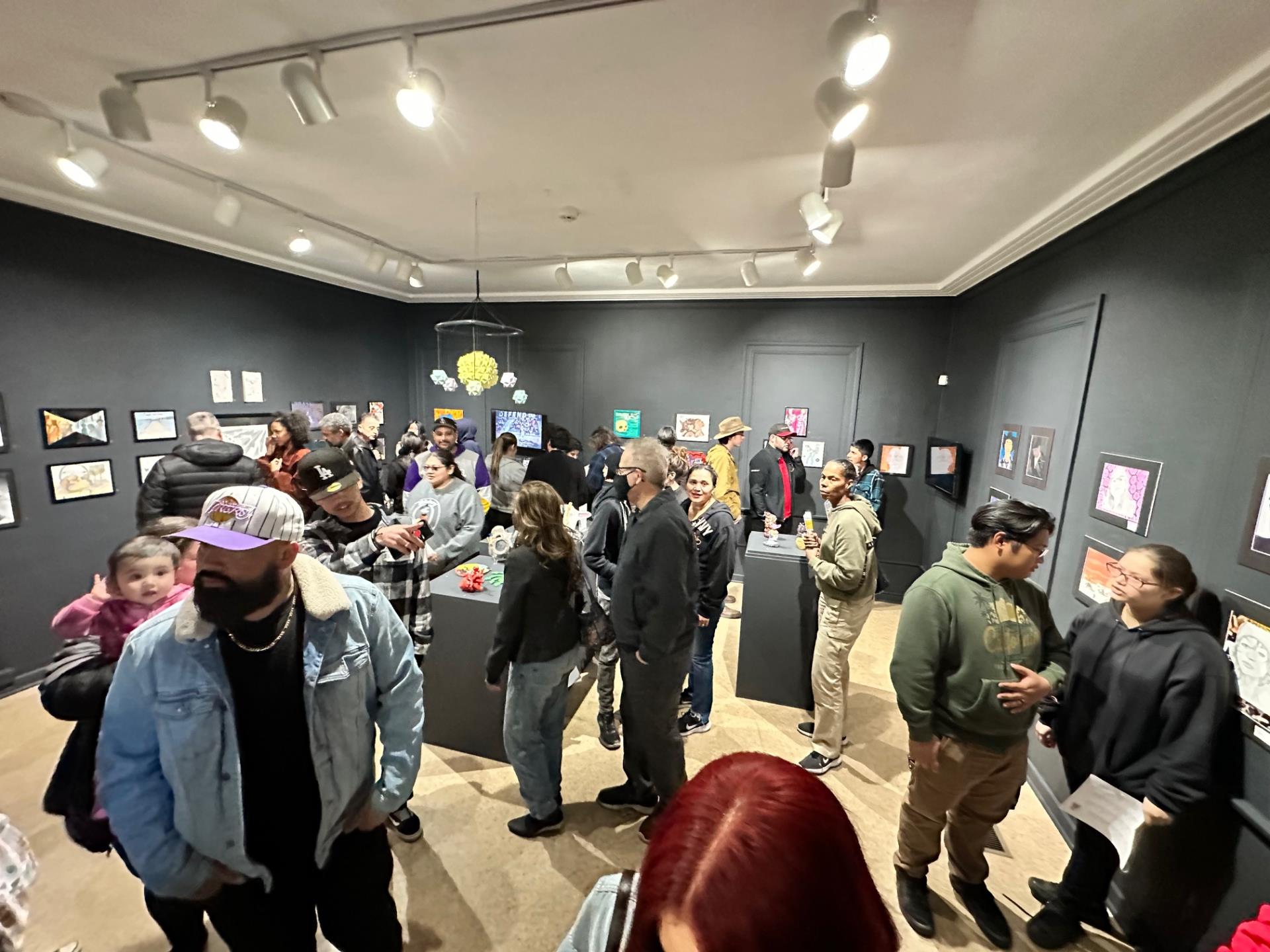 visitors walk through the moah:cedar student exhibition area