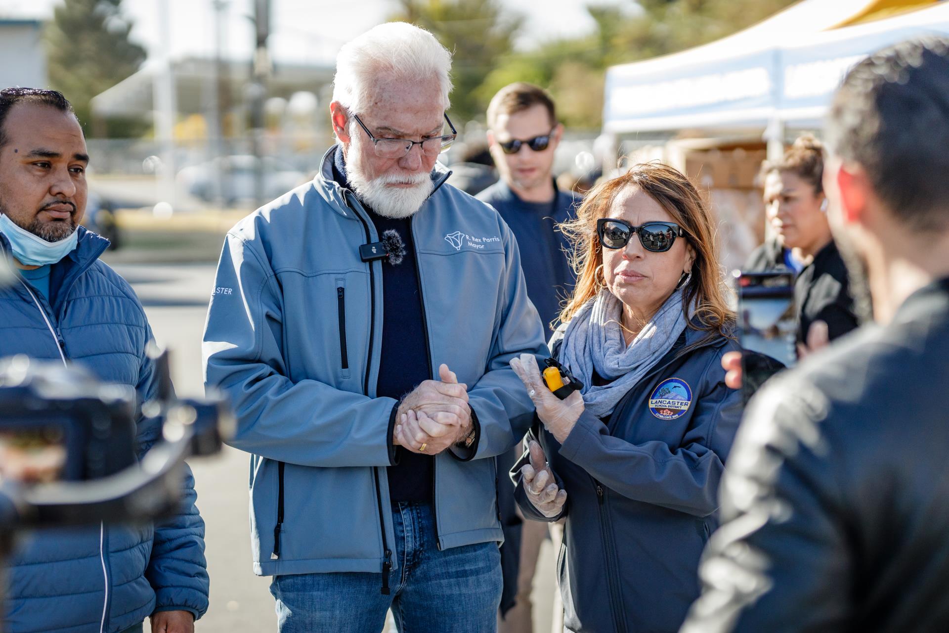 Mayor Parris stands with volunteers at a community event