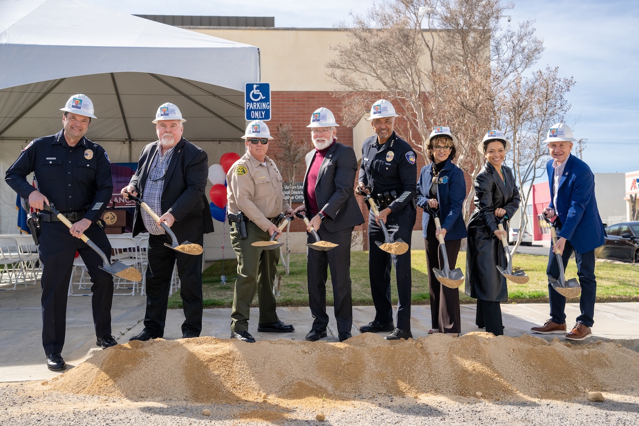 leaders at lancaster police station use shovels to dig up dirt at the groundbreaking ceremony