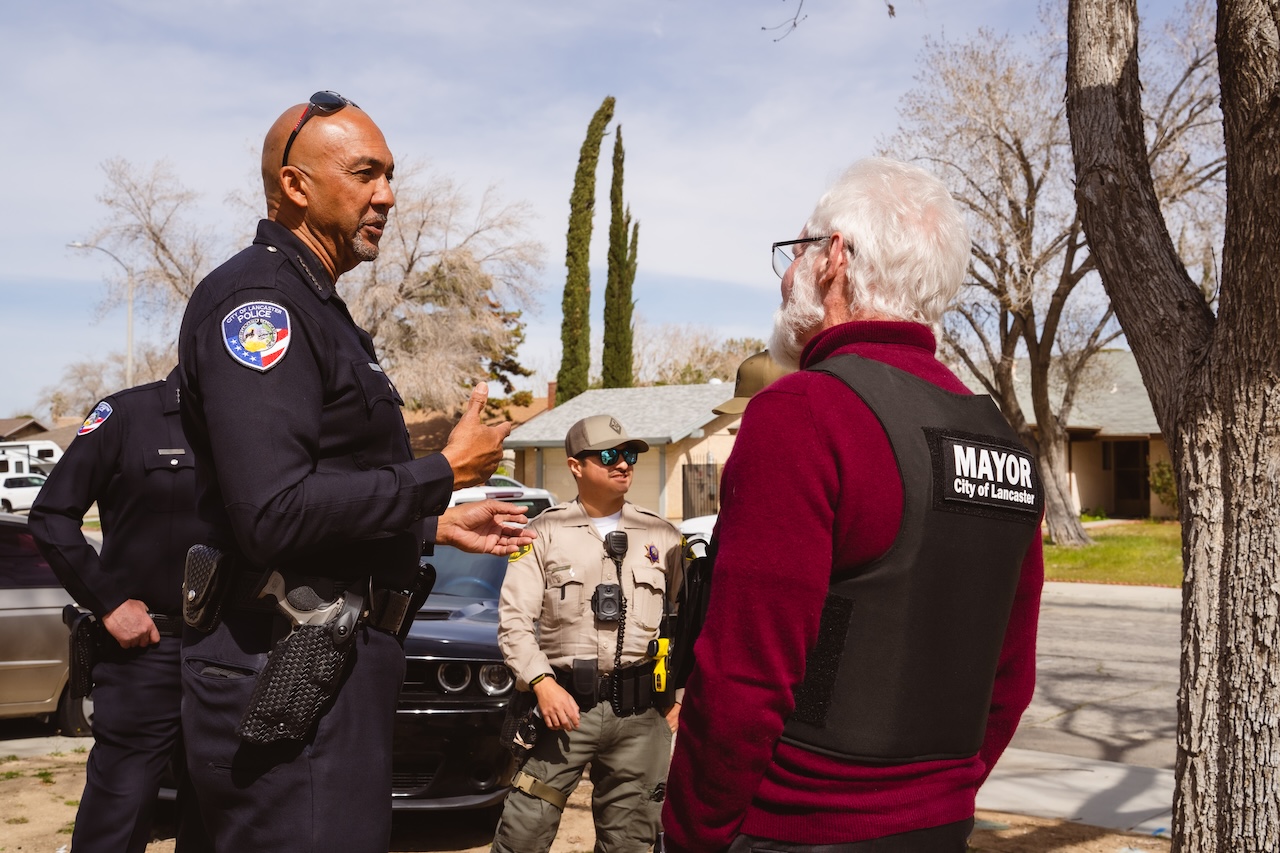 law enforcement and lancaster's mayor parris discussing the operation outside