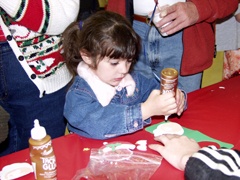 Young girl making Christmas crafts.