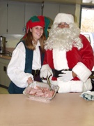 Santa and a helper preparing Christmas snacks.