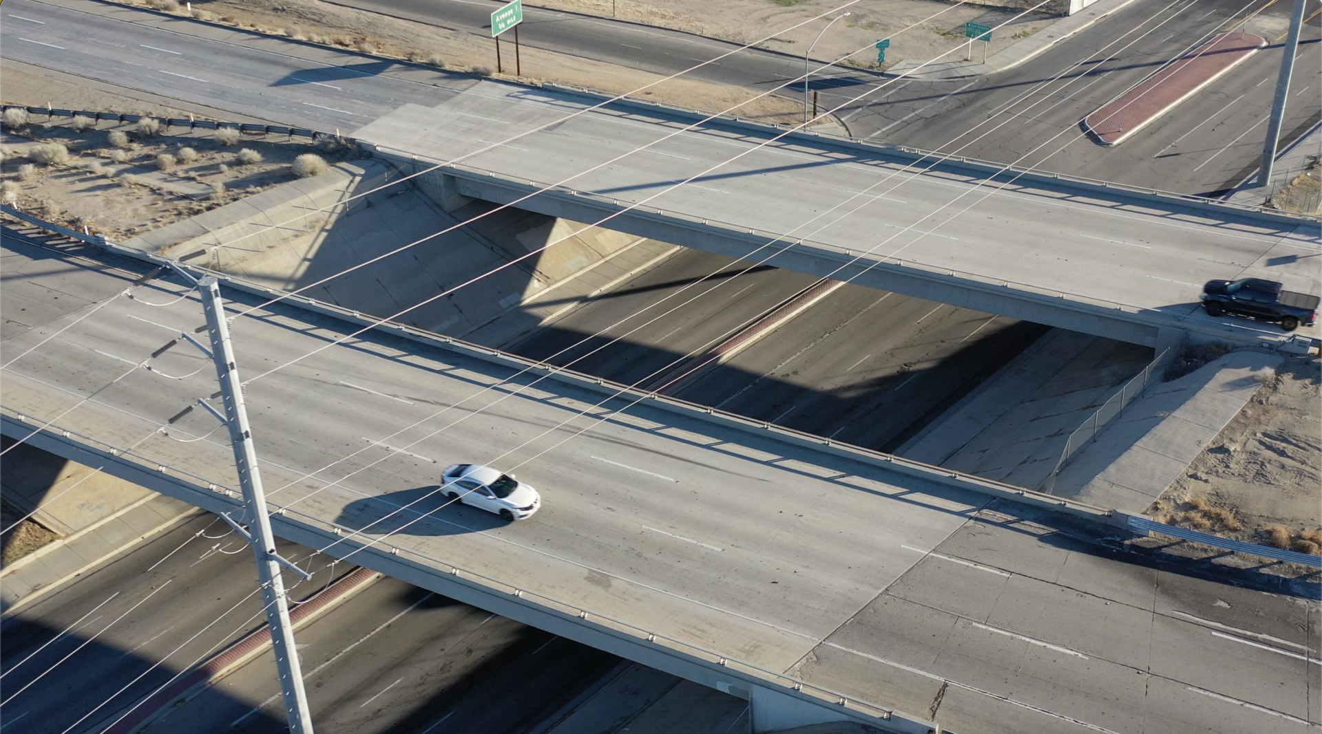 aerial shot of sr-14 freeway with only one, white car visible on the roadways