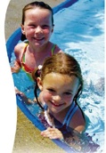 Two girls swimming in a pool.